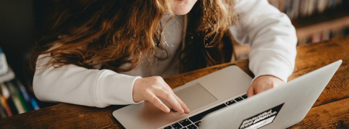 young female student on laptop for internet safety blog