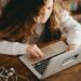 young female student on laptop for internet safety blog