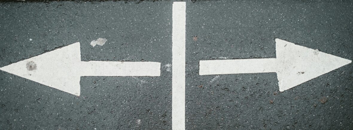 arrows pointing both ways on a street signifying re-trafficking