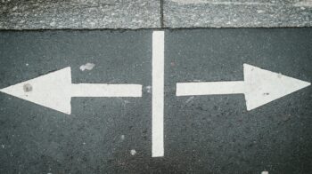arrows pointing both ways on a street signifying re-trafficking