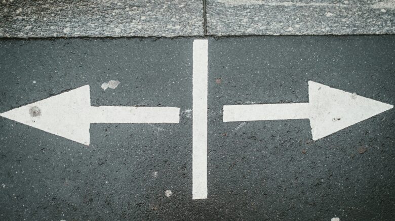 arrows pointing both ways on a street signifying re-trafficking