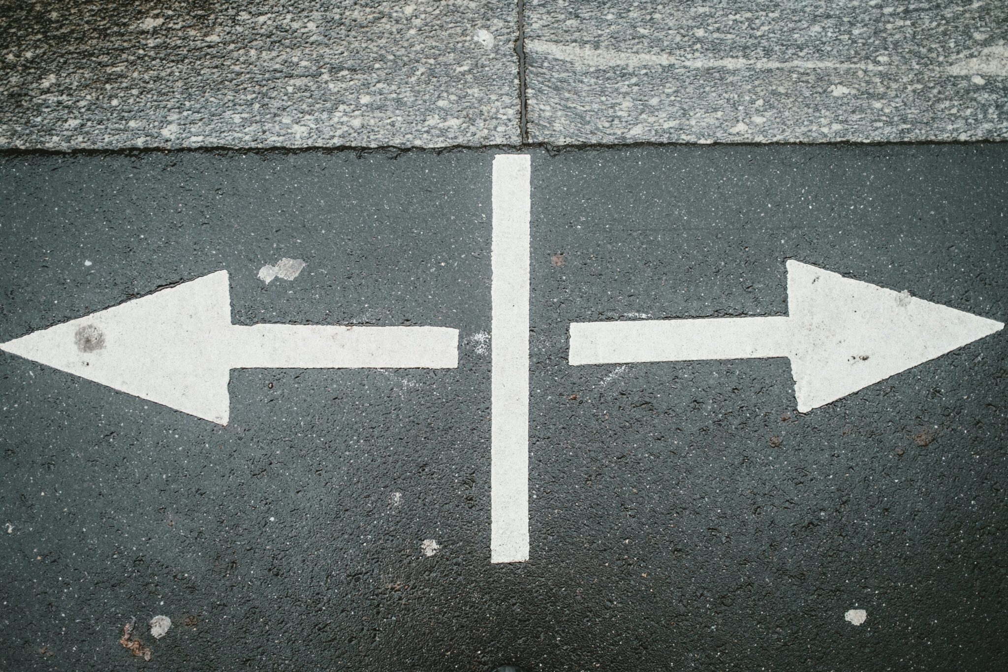 arrows pointing both ways on a street signifying re-trafficking